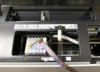 Note: Before continuing, check that each CFS cartridge has a chip, as cartridges without a chip can damage the printer. Install the CFS cartridge through the left opening in the printer housing.
