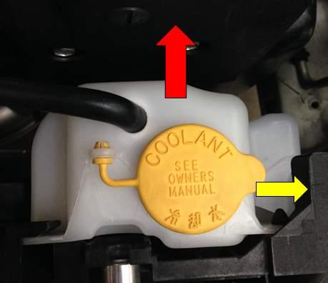 Remove the coolant overflow line from the top of the tank.