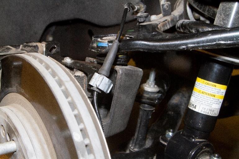 Use a socket on the bottom of the sway bar end link under