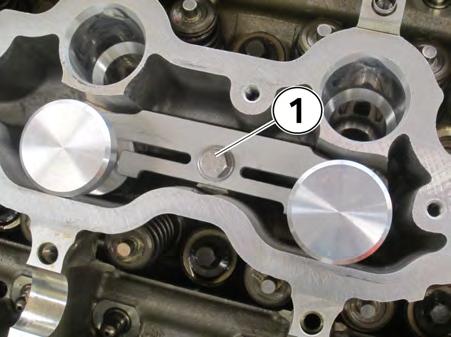 Reinstall the injector hold-down bracket and torque the M7