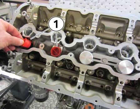 Install the two red plugs into the remaining open injector