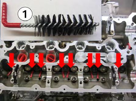 8. Install the eight supplied plug brushes (1) into the eight oil drain back holes (see arrows) in the cylinder head,