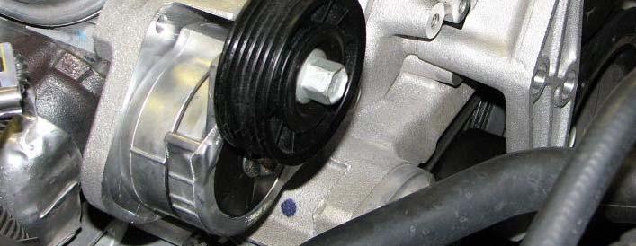 Use a 15mm wrench to remove two bolts retaining the power steering reservoir bracket.