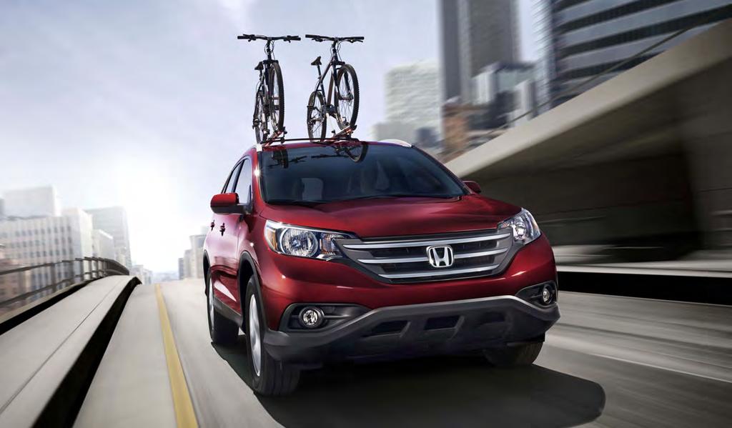 GENUINE ACCESSORIES CR-V AWD EX-L shown in Basque Red Pearl II with accessory crossbars and bike attachement.