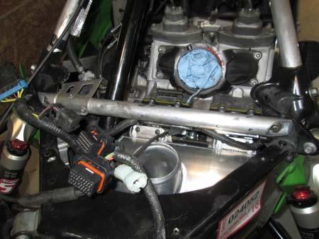 25. Secure air box by removing the fuel rail screws,