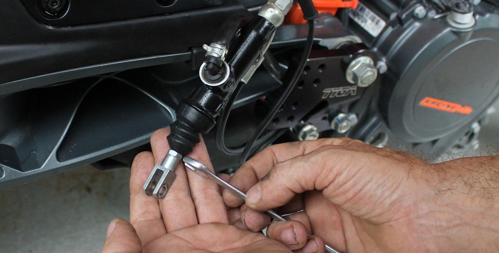 The lever stopper is located under the brake lever.