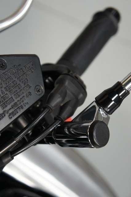 C) Bolt on the right hand handlebar end cap. The stock end cap can not be used and a set like this must be purchased.