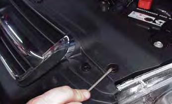 Open hood and remove six plastic push fasteners