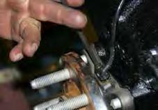 Remove the OEM brake line brackets & OEM brake caliper mounting bolts from the OEM steering knuckles using a 10mm socket / wrench & a 21mm socket / wrench.