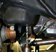 21. Drill the two OEM sway bar mounting bracket holes located on the driver side frame using a drill & 1/2" drill bit. (See Photo # 13) 22.