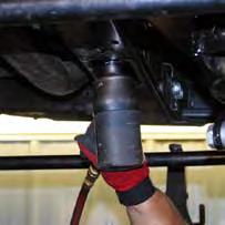 42. Locate the transmission cross member. Using a 15mm wrench, remove the transmission skid plate.