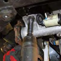 With the welds ground off, remove the cross member mounting bolts using a 18mm wrench.