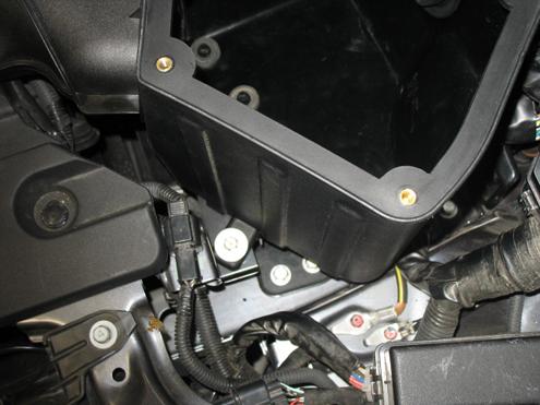 f) Align the tab on the airbox with the mounting location