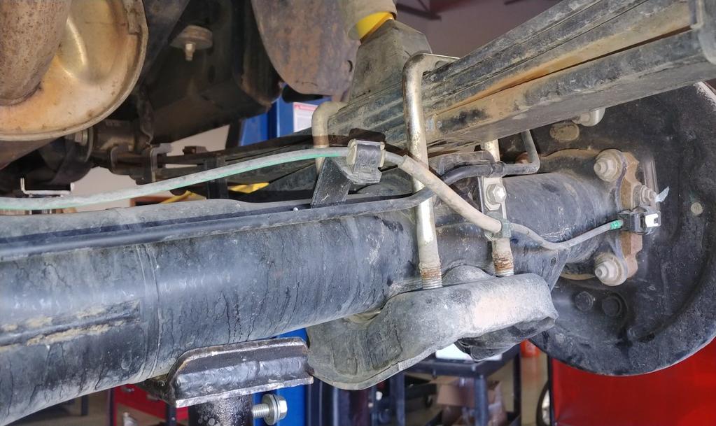 Raise the axle while lining up the center pins. Install the provided u-bolts and hardware. Do not tighten fully, leave loose so that you can repeat the steps for the opposite side.