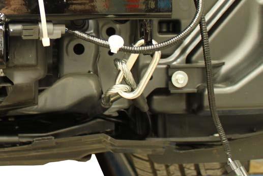 23. Attach the permanent baseplate safety cables to the provided convenience link on the baseplate. The photo shows the recommended installation of the cables to frame of vehicle.