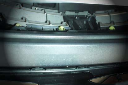 Looking from underneath the vehicle and toward the bumper, visually locate the