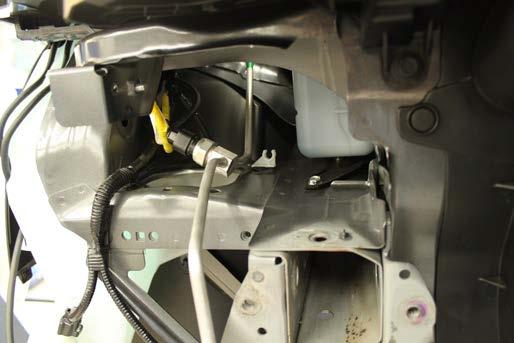 15. On the passenger side, unsnap the coolant line out of the bracket and carefully move over