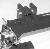 . Slot in L-shaped attachment allows access for bolting attachment directly to reference hole on side of frame rail or for straddling bolt that projects from rail s