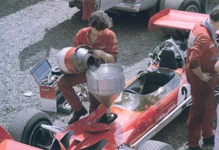 Colour Gallery 2 The way it was: Herbie Blash pours a churn of fuel into Rindt s 49 (in the paddock at Silverstone during the 1969 British Grand