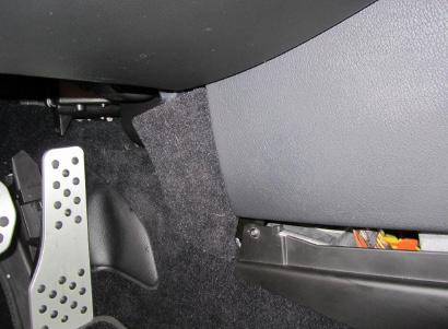 Locate the 2 carpeted kick panels in the very front of