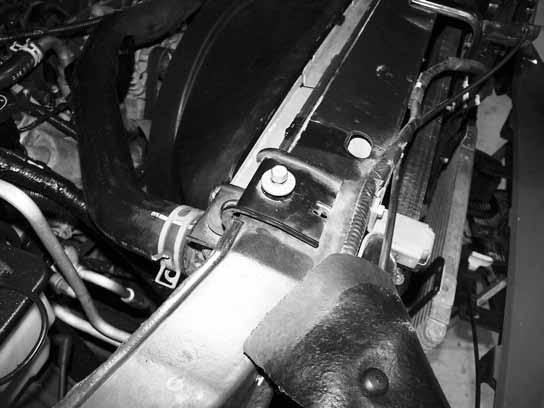 Pull the shroud up and out past the fan hub and radiator. Set the shroud aside to be modified later. Figure 19 37. Drain the radiator into a clean container. 38.