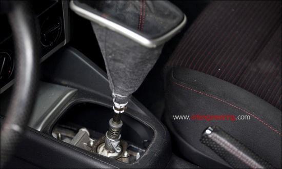 Move to the inside of the vehicle. Remove the shift boot by gently lifting up on the on the rear portion of the boot.