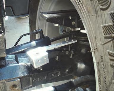 Mount WK with its rearmost edge parallel to the cast ridge along the top of the axle casing (Figure 2b, bottom inset) and with its WAS assembly mounting bolt holes upward (Figure 2b).