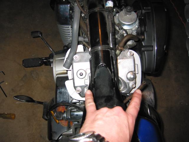 (Pic 1) This is what you should see. (Pic 2) The valve stem runs along inside those springs. It gets pushed down by the rocker arm from above. The gap between the two is what you're about to adjust.