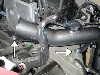Remove the bolt that secures the air duct / ribbed hose assembly, and then remove the assembly