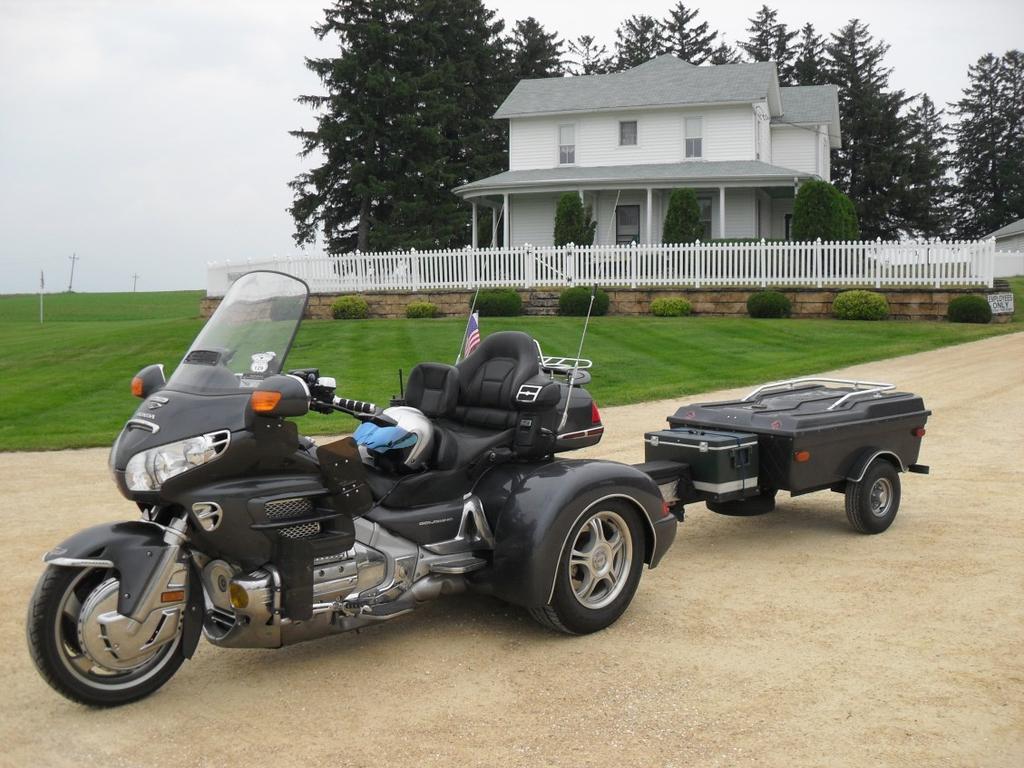 When not on the road, the trike and trailer are always under cover. The trike and trailer go as one unit. They will not be separated. Trike Extras: CB Radio. 12 Volt outlets front and rear.