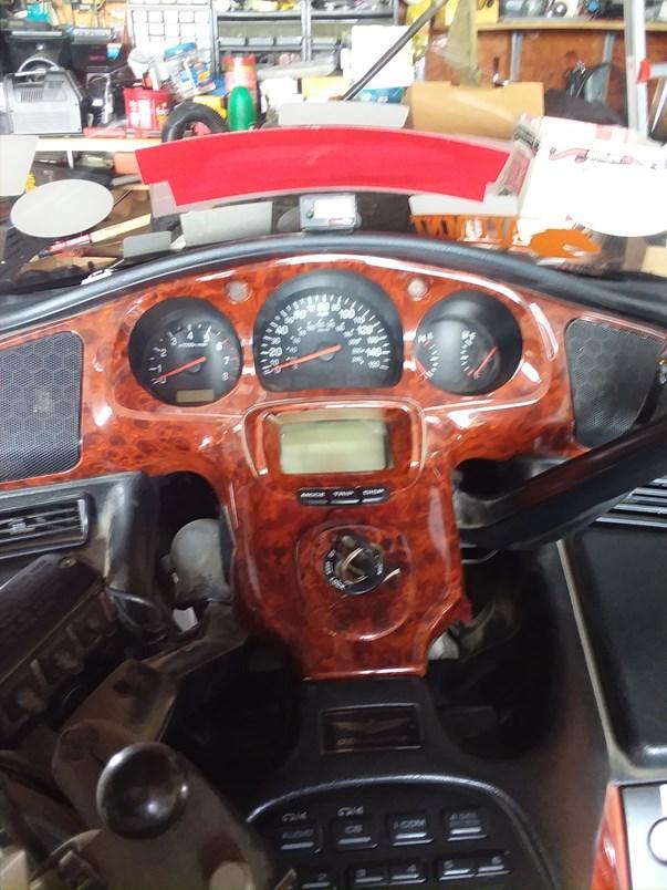 It has a vinyl bra that covers the front headlight area. The tires appear good but would probably need to be replaced due to age. The picture shows that it has a custom dash and a CB.