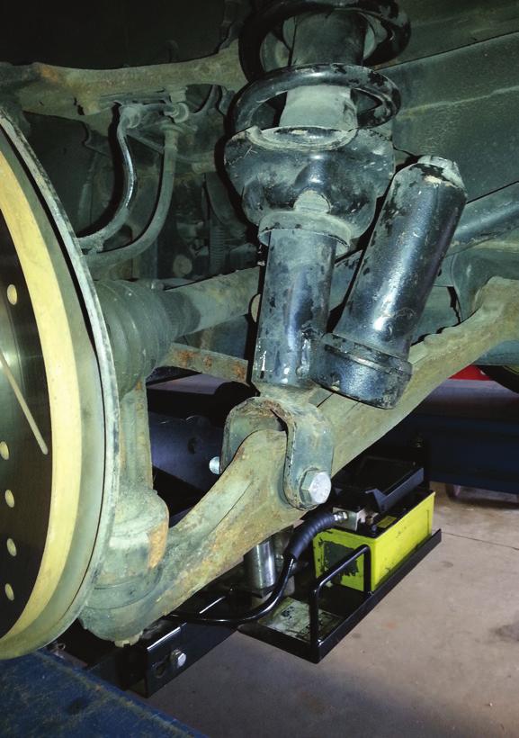 2. Unbolt the lower shock mount from the control arm. Remove the shock from the vehicle. (Figs.