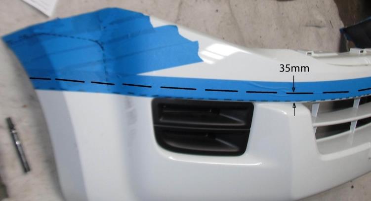 Mark up the first cut line, all the way around the bumper, 35mm above the upper external bumper corner as shown on the