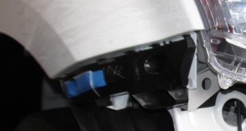 19. Carefully remove the RH and LH black plastic bumper retaining brackets.