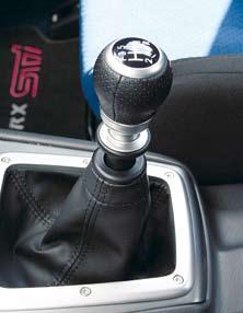 Close-up view of STi gear shift with pull-up reverse ring. STi aluminium pedals with rubber offer better grip and a sportier look. Rubber protector fitted to Impreza WRX.