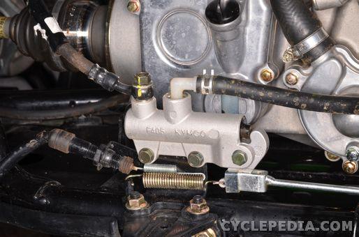 Install the two master cylinder mounting bracket nuts with a 12 mm socket and tighten them securely. Connect the brake hose to the master cylinder.