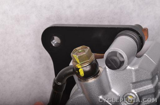 Disassembly Remove the brake hose banjo bolt with a 12 mm socket.
