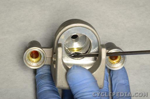 Use a mechanics pick to remove the piston fluid seal from