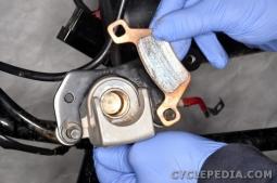 Install the brake pads. Fit the brake caliper into place. Guide the brake disc between the pads.