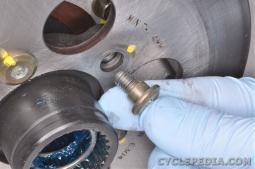 Install the five rear brake disc mounting bolts and tighten them to