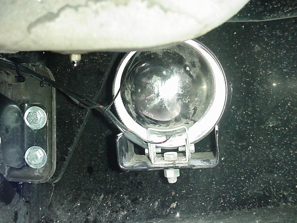See Figure 15. Figure 15: Light Mounted to Bumper. 16. Install the front license plate to the front of the bumper under the winch fairlead opening.