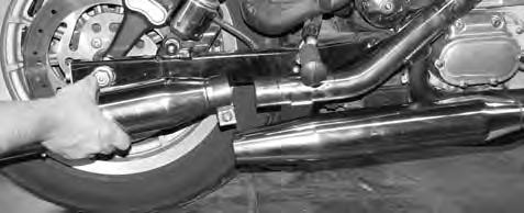 (Flat Head Screwdriver) The exhaust hanger bracket must be removed before exhaust canisters can be removed