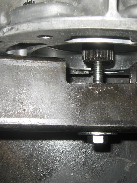 Disconnect the wiring harness from the tailhousing by prying up the retaining clip on the driver's side of tailhousing.