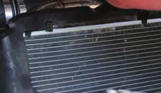 Reinstall the transmission cooler and cooler lines to the radiator using two 8mm bolts. 36.