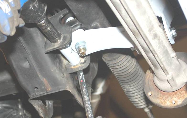 Install rear cross-member using factory bolts and install differential bolt with new mm nut shown in