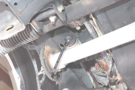 It may be necessary to slightly turn the steering wheel to allow the bolt to clear