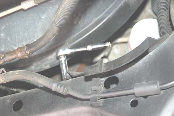 5. Remove the oil catch pan using 0mm wrench. See Photo 9. 6.
