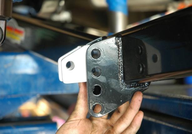 There are a total of 4 holes which allow 3 different positions in which you can install the lower shock mount.