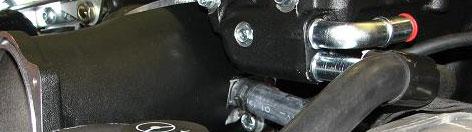 Since two of the stock manifold bolt hole provisions in the cylinder heads break into the crankcase and are not used with this supercharger, install the button head bolts supplied in