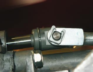 The shifter has a bushing shaft held in place with a clip that must be removed before the